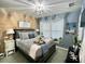 Comfortable bedroom with a wood accent wall, stylish décor, and plenty of natural light at 8811 White Sage Loop # 8811, Lakewood Ranch, FL 34202