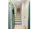 Inviting foyer with tile floors, staircase, and green door with decorative wreath at 8811 White Sage Loop # 8811, Lakewood Ranch, FL 34202