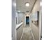 Bright hallway features neutral paint, carpet and artwork at 8811 White Sage Loop # 8811, Lakewood Ranch, FL 34202
