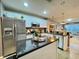 Well-equipped kitchen with stainless steel appliances, kitchen island, and stylish backsplash at 8811 White Sage Loop # 8811, Lakewood Ranch, FL 34202