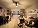 Spacious recreation room with stylish seating, a vintage lounge sign, and access to the garage at 8811 White Sage Loop # 8811, Lakewood Ranch, FL 34202