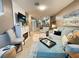 Open-concept living room featuring a fireplace, hardwood floors, and comfortable seating at 8811 White Sage Loop # 8811, Lakewood Ranch, FL 34202
