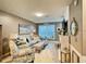 Comfortable living room with stylish furniture, neutral colors, and lots of natural light at 8811 White Sage Loop # 8811, Lakewood Ranch, FL 34202