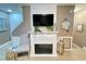 Cozy living room fireplace with elegant decor and comfortable chair at 8811 White Sage Loop # 8811, Lakewood Ranch, FL 34202