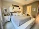 The main bedroom features a king bed, neutral decor, and ample natural light at 8811 White Sage Loop # 8811, Lakewood Ranch, FL 34202