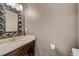 Modern bathroom with dark brown vanity, white countertop, and gold fixtures at 214 S Westland Ave # 1, Tampa, FL 33606