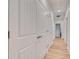 Long hallway with white paneled doors and light wood floors at 214 S Westland Ave # 1, Tampa, FL 33606