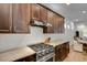 Stainless steel gas range and dark wood cabinetry in modern kitchen at 214 S Westland Ave # 1, Tampa, FL 33606