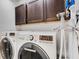 Laundry room with washer, dryer, and ample storage cabinets at 214 S Westland Ave # 1, Tampa, FL 33606