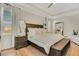 Main bedroom with a king bed, wood furniture, and large mirror at 214 S Westland Ave # 1, Tampa, FL 33606