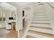 Elegant staircase with white railings and hardwood steps leading to the second floor at 214 S Westland Ave # 1, Tampa, FL 33606