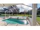 A screened in pool and view of manicured lawn at 26311 Seminole Lakes Blvd, Punta Gorda, FL 33955