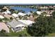 Aerial view of a home featuring a lovely screened pool, a well-kept yard, and a tranquil water view at 26311 Seminole Lakes Blvd, Punta Gorda, FL 33955