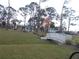 Relaxing gazebo and charming footbridge in a lush green space at 6337 Fantasy Ct, North Port, FL 34287