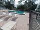 Community pool with plenty of lounge chairs for sunbathing at 6337 Fantasy Ct, North Port, FL 34287