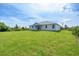 Single-story home with large backyard and surrounding vegetation at 9245 Zorn St, Port Charlotte, FL 33981