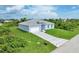 Aerial view of a light blue single story home with a grassy yard at 9245 Zorn St, Port Charlotte, FL 33981