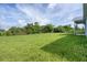Large grassy backyard, partial house view at 9245 Zorn St, Port Charlotte, FL 33981
