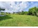 Large grassy backyard with partial view of house at 9245 Zorn St, Port Charlotte, FL 33981