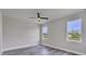 Spacious bedroom with grey flooring and two windows at 9245 Zorn St, Port Charlotte, FL 33981