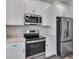 Stainless steel range and microwave in a modern kitchen at 9245 Zorn St, Port Charlotte, FL 33981