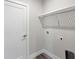 Laundry room with white cabinets and built in shelving at 9245 Zorn St, Port Charlotte, FL 33981