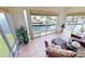Relaxing sunroom with water views and wicker furniture at 1 Colony Point Dr # 5C, Punta Gorda, FL 33950