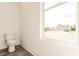 Simple bathroom with toilet and window at 1309 Nackman Rd, North Port, FL 34288