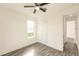 Bright bedroom with wood-look floors and ceiling fan at 1309 Nackman Rd, North Port, FL 34288