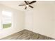 Spacious bedroom with wood-look floors, a ceiling fan, and large window at 1309 Nackman Rd, North Port, FL 34288