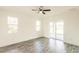 Bedroom with sliding glass doors to patio and wood-look floors at 1309 Nackman Rd, North Port, FL 34288