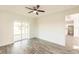 Bedroom with sliding glass doors to patio and wood-look floors at 1309 Nackman Rd, North Port, FL 34288