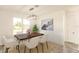 Elegant dining area with wood table and modern chandelier at 1309 Nackman Rd, North Port, FL 34288