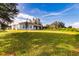 Single story home with backyard and green landscape at 1309 Nackman Rd, North Port, FL 34288