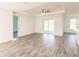 Bright and airy living room with wood-look floors and sliding doors at 1309 Nackman Rd, North Port, FL 34288