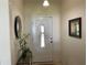 Bright entryway with white door, decorative mirrors, and a small table at 3401 Schuster St, North Port, FL 34291