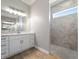 Bathroom with white cabinets, marble shower, and modern fixtures at 9453 Zorn St, Port Charlotte, FL 33981