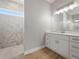 Bright bathroom boasts white cabinets and a marble shower at 9453 Zorn St, Port Charlotte, FL 33981