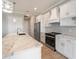 White cabinets, marble countertops, and stainless steel appliances at 9453 Zorn St, Port Charlotte, FL 33981