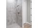 Shower with marble tile and modern fixtures at 9453 Zorn St, Port Charlotte, FL 33981