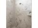 Walk-in shower with marble tile and modern fixtures at 9453 Zorn St, Port Charlotte, FL 33981