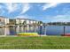 Kayaks on grassy waterfront with boat slips and condo building in background at 3670 Bal Harbor Blvd # 1F, Punta Gorda, FL 33950