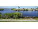 Waterfront view of community with lush landscaping and calm waters at 542 Tampico Dr, North Port, FL 34287