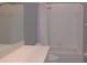 Clean bathroom with white tile, shower/tub combo, and vanity at 2081 Lynx Run, North Port, FL 34288