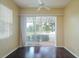 Bright living room with dark hardwood floors and sliding glass doors to a screened porch at 2081 Lynx Run, North Port, FL 34288