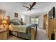 Main bedroom with king bed, patio access and ceiling fan at 745 Columbia St, Port Charlotte, FL 33948