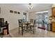 Bright dining area with glass table and four chairs, adjacent to kitchen at 745 Columbia St, Port Charlotte, FL 33948