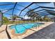 Inviting kidney-shaped pool with screened enclosure at 745 Columbia St, Port Charlotte, FL 33948