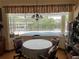 Bright dining area with water views and a table for four at 18029 Ohara Dr, Port Charlotte, FL 33948