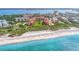 Aerial view of beachfront condo community with lush landscaping and pool at 8750 Midnight Pass Rd # 202, Sarasota, FL 34242